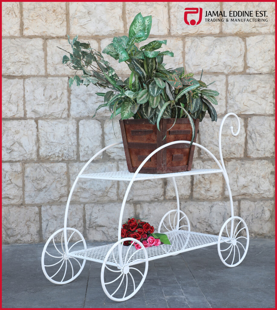 white wrought steel garden cart with wheels for decoration with red and white flowers on it