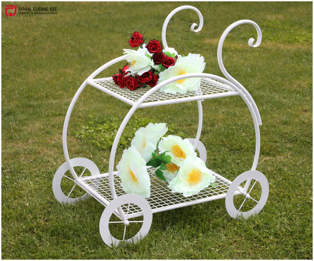 white wrought steel garden cart for decoration with red and white flowers on it